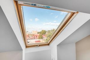 a skylight window in a room with white walls at 3 bedroom with parking by the station in Norwich