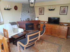 a living room with a couch and a fireplace at La Vista de Gredos in Navarredonda de Gredos