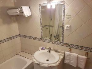 a bathroom with a sink and a shower and a tub at La Vista de Gredos in Navarredonda de Gredos