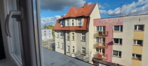 a view of a building from a window at Hostel Centrum-Kamienica 1924 in Szczecinek
