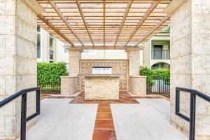 a patio with a wooden pergola in a building at Stunning & Spacious Apartments at Miramar Lakes in South Florida in Miramar