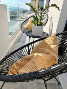a black chair with a pillow on a balcony at Noi leisure stay 3 in Neoi Epivates