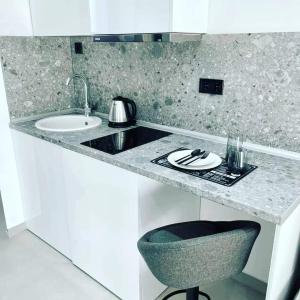 a kitchen with a counter with a sink and a chair at Noi leisure stay 3 in Neoi Epivates