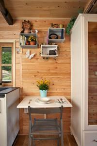 a tiny kitchen with a table and a chair at Tiny house AMBAR in Starčevljani