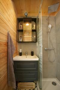 a bathroom with a sink and a shower at Tiny house AMBAR in Starčevljani