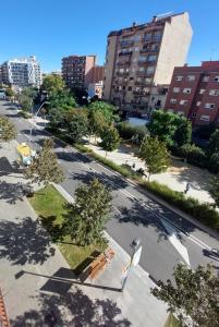 an empty street in a city with tall buildings at Clot MiraBarna Apartments in Barcelona