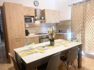 a kitchen with a table and chairs in a kitchen at GOZO TA CENC RESIDENCE WITH COMMUNAL POOL in Sannat