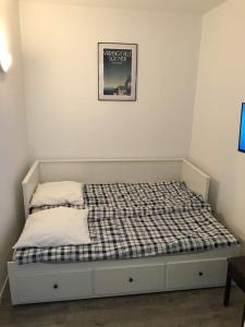 Bett in einem Zimmer mit einem Bild an der Wand in der Unterkunft Studio Le Galet idéalement situé en centre ville in Dieppe