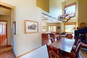 a dining room and living room with a table and chairs at Snowmass Village, 3 Bedroom Condo at Chamonix, Ski-in Ski-out in Snowmass Village