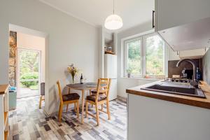a kitchen with a table and chairs and a sink at Beach House Escape in Gdynia