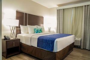 a bedroom with a large bed in a hotel room at Comfort Inn & Suites Tobago in Tobago Island