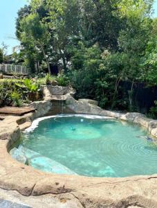 a large pool of blue water in a yard at Angazi Guesthouse Unit 3 - Modern 2 Bedroom Apartment with Pool in Hillcrest
