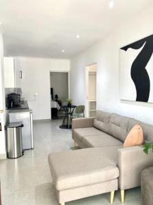 a living room with a couch and a table at Angazi Guesthouse Unit 3 - Modern 2 Bedroom Apartment with Pool in Hillcrest