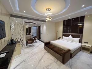 a hotel room with a bed and a desk and a room at Lime Tree Hotel and Banquet Greater Noida in Greater Noida