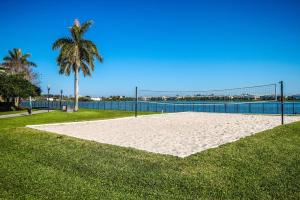 una rete da pallavolo su una spiaggia con una palma di Bright and Modern Apartments at Palm Trace Landings in South Florida a Davie