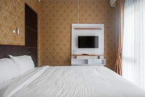 Ein Bett oder Betten in einem Zimmer der Unterkunft The Lavana Greenkhaza Villa Jogja