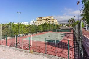a tennis court in front of a building at Sunshine by the ocean 1BR apartment COSTA ADEJE by Aqua Vista Tenerife in Adeje