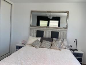 a bedroom with a bed with a mirror above it at Casa puerto Isla Plana - Grande in Isla Plana +23 photos