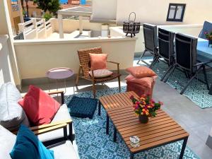 a patio with couches and a table and chairs at Casa puerto Isla Plana - Grande in Isla Plana