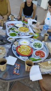 a table topped with plates of food at Thara Real Estate in Sowayma