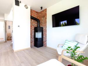 a living room with a brick wall and a fireplace at Dom nad Zatoką in Puck