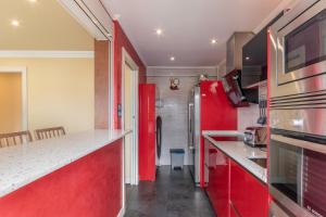 a kitchen with red cabinets and a red refrigerator at Bilbao Airport by Aston Rentals in Derio