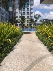a walkway leading to a swimming pool in a building at Seawind Condominium 2BR unit in Davao City