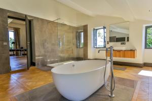 a large bathroom with a tub and a shower at CHATEAU DE LASCOUPS in Saint-Martin-des-Combes +19 photos