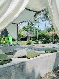 a bed with pillows sitting on it under a tent at Satta Beach Residence in Varkala