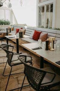 a group of tables and chairs in a room at Hotel Palais26 in Villach