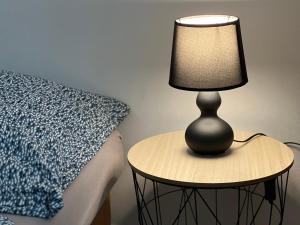 a lamp sitting on a table next to a bed at Motorest Farmárik in Topoľčany