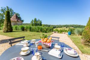 a table with a blue table cloth with food on it at CHATEAU DE LASCOUPS in Saint-Martin-des-Combes