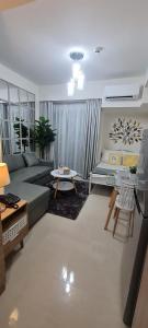 a living room with a couch and a table at Inspiria Condo Units beside Abreeza Mall Davao in Davao City
