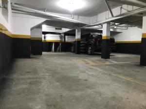 a parking garage with a car parked in it at Hotel Novo Apúlia in Sao Paulo