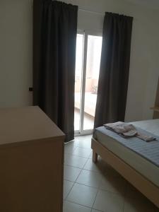 a bedroom with a bed and a sliding glass door at Residence Por Do Sol, Praia Cabral, Boa Vista, Cape Verde, FREE WI-FI in Sal Rei
