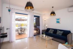 a living room with a couch and a table with an umbrella at Captivating 2-Bed Villa in Playa Blanca in Playa Blanca