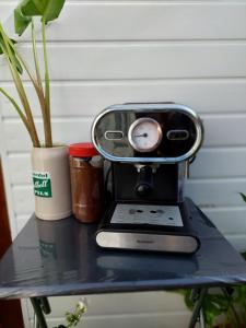 a table with a coffee maker and a clock on it at Beautiful Apartment in Bristol