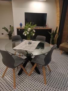 a dining room with a glass table and chairs at A casa di Mammì nella Valle dei templi in Agrigento