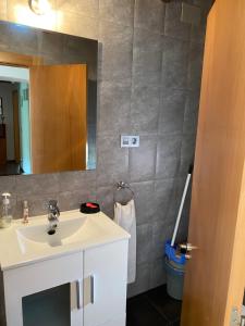 a bathroom with a white sink and a mirror at El Descanso Lastres in Colunga