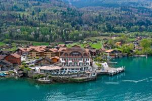 an aerial view of a town on the water at Hotel Strandhotel in Iseltwald