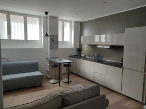 a kitchen with a couch and a table in a room at Fiera City Life 2 Top Apartment in Milan
