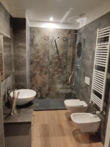 a bathroom with two toilets and a sink at Fiera City Life 2 Top Apartment in Milan