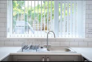 a kitchen with a sink and a window at Groves House Swansea City Centre No pets in Swansea