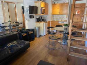 a living room with a table and a couch at Central 3 bedroom chalet with balcony in Val-d'Isère