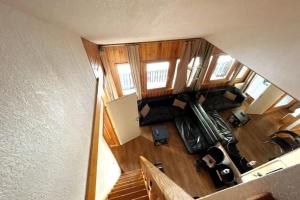 an overhead view of a living room with a staircase at Central 3 bedroom chalet with balcony in Val-d'Isère