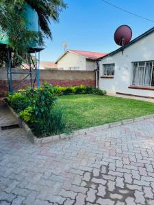 a brick driveway in front of a house at Remarkable 2-Bed House in Bulawayo in Bulawayo