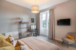 a bedroom with a bed and a window at The Woodside in Doune