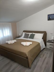 a bedroom with a large bed with two towels on it at B&B Carpe Diem in Caserta