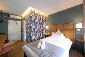 Postel nebo postele na pokoji v ubytování Hotel-Restaurant Axion