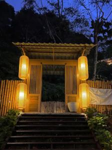 a gazebo with two lights and stairs at night at Kireina Genting Villa in Genting Highlands